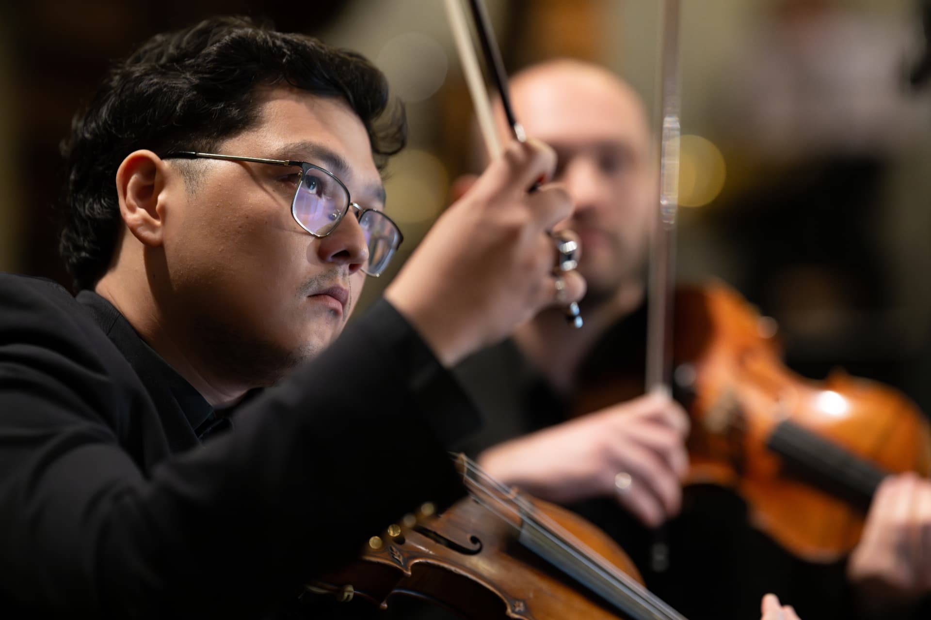 Violinist of the Empyrean Orchestra with raised bow
